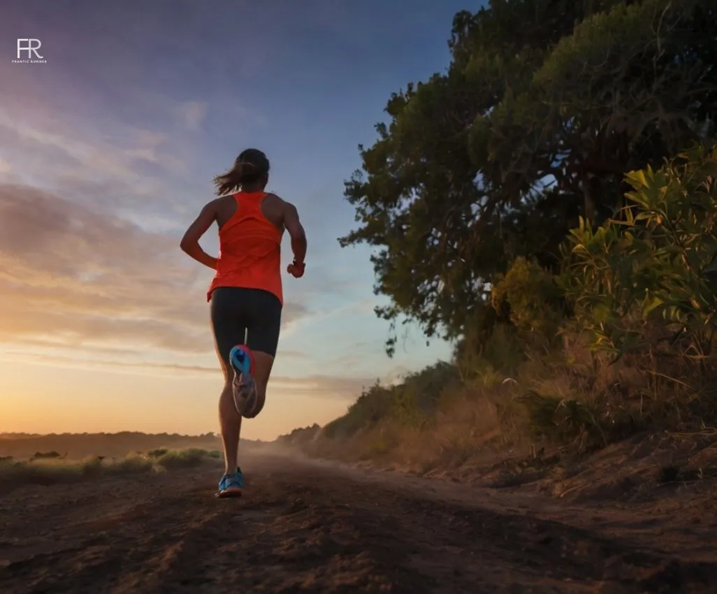 a close-up image of a runner wearing vibrant running gear & shoes, while exercising for the 9 benefits of running before sunrise